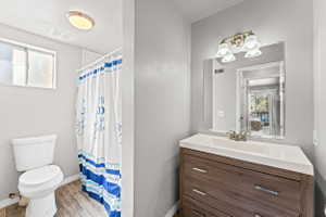 Bathroom featuring vanity, a shower with shower curtain, and light wood finished floors