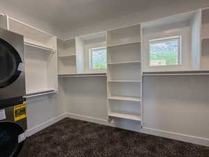Walk in closet featuring stacked washer and dryer