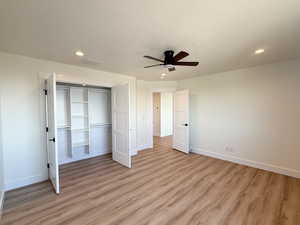 Unfurnished bedroom featuring light wood-type flooring, a textured ceiling, a ceiling fan, a closet, and recessed lighting