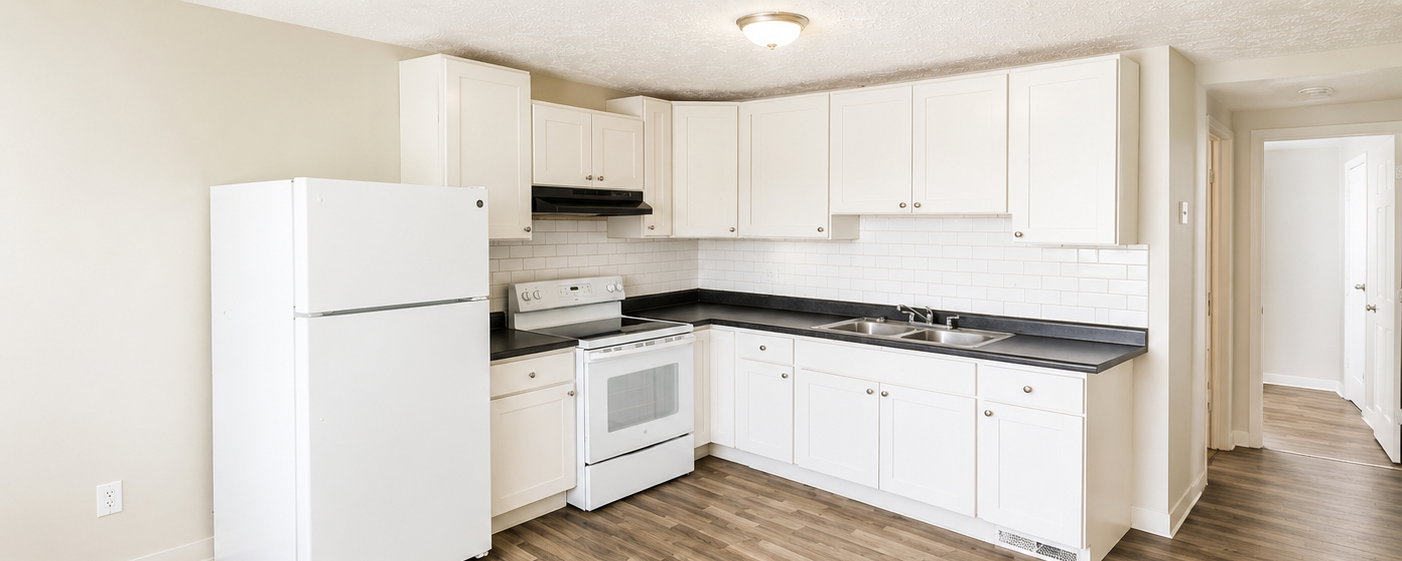 Kitchen featuring white cabinetry, dark countertops, a white subway tile backsplash, stainless steel double basin sink, and wood-finish flooring
