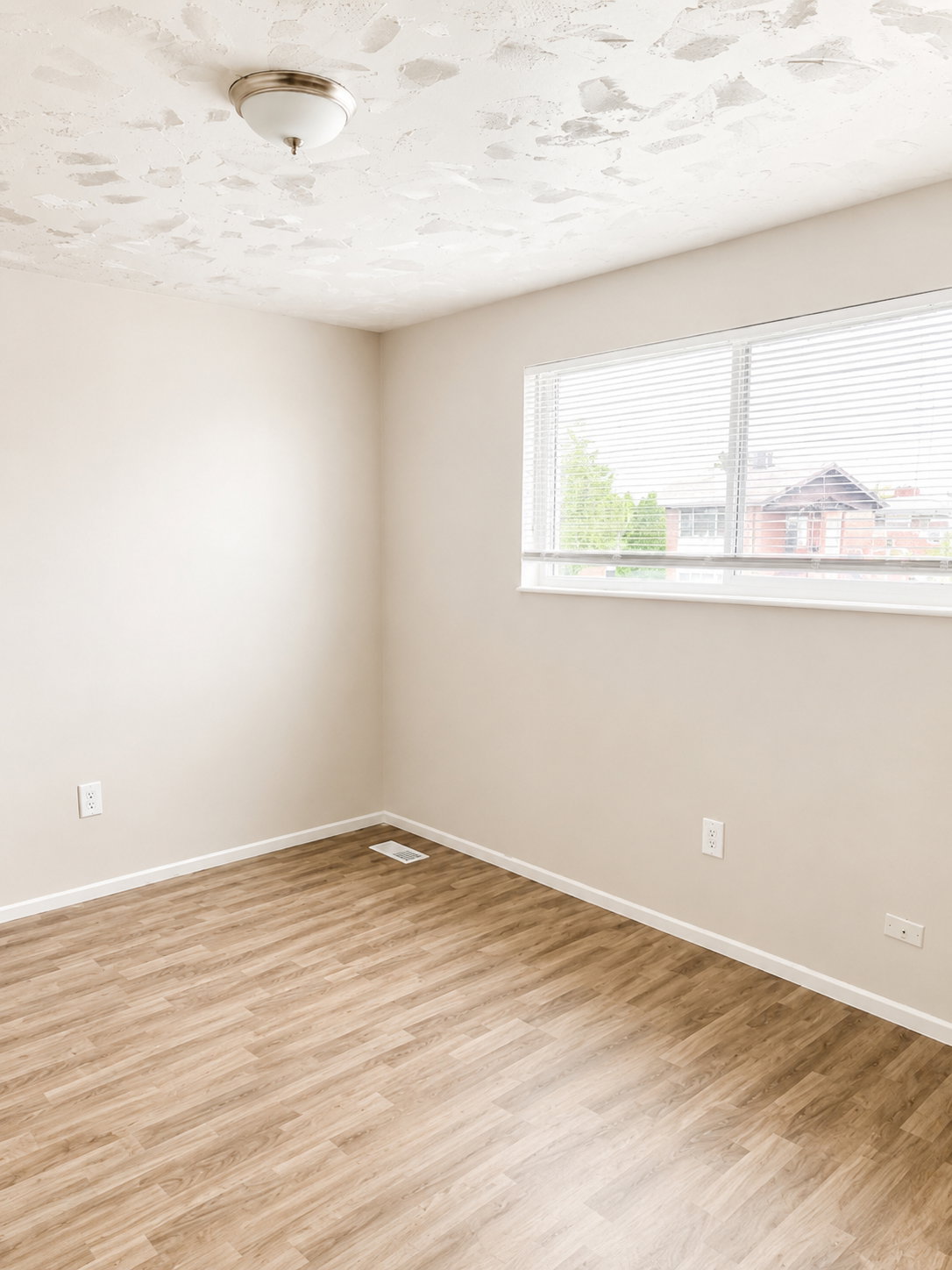 Room featuring wood-finish flooring, neutral wall paint, and a rectangular window with blinds
