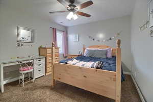 Bedroom with dark colored carpet and ceiling fan