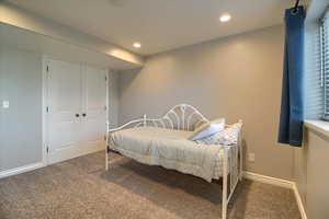 Bedroom with carpet, recessed lighting, and a closet