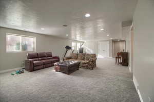 Carpeted living area with recessed lighting