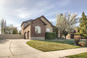 Mediterranean / spanish-style home featuring concrete driveway, stucco siding, and brick siding