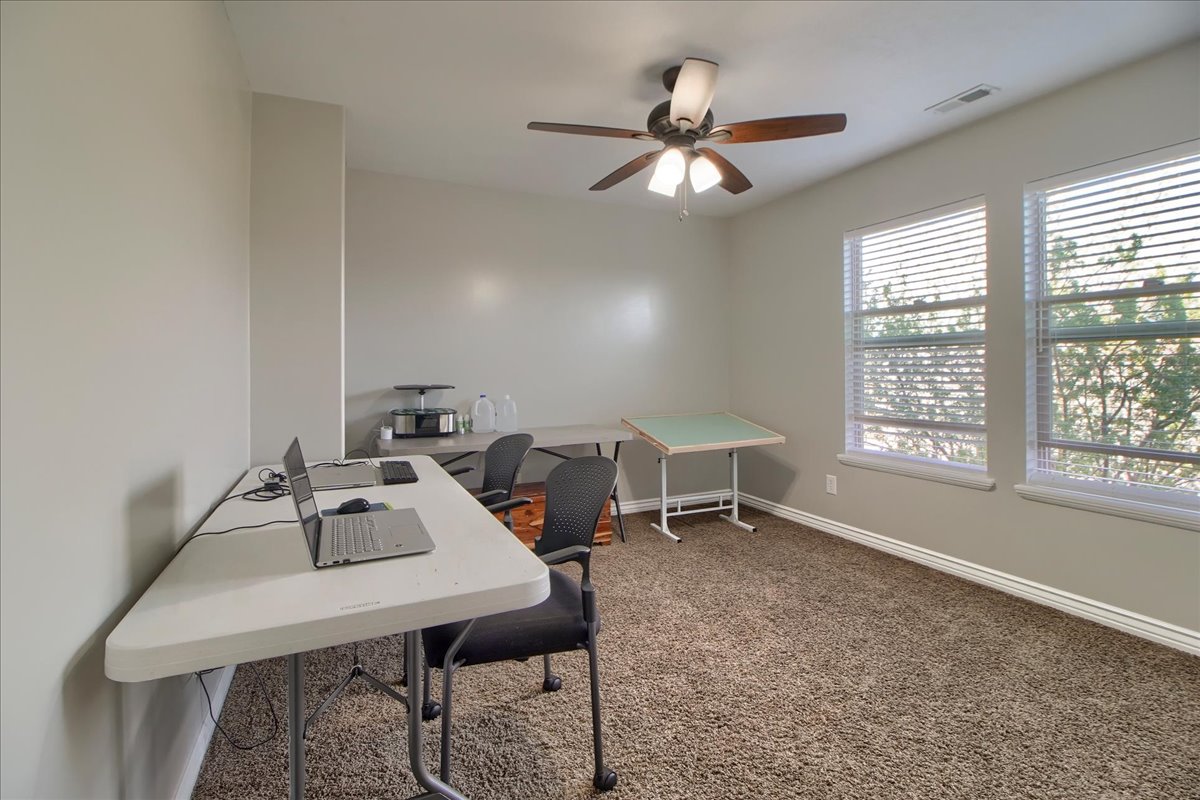 Office space featuring ceiling fan and carpet floors