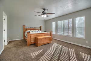 Bedroom featuring dark carpet and ceiling fan