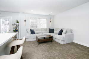 Carpeted living room with baseboards