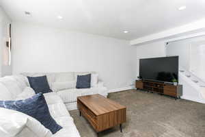Carpeted living area featuring recessed lighting
