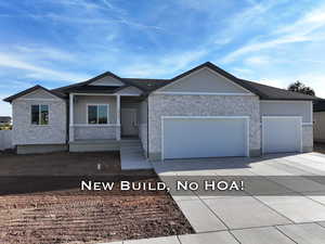 Single story home featuring a garage, covered porch, and concrete driveway