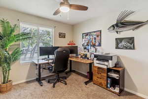 Home office featuring light colored carpet and ceiling fan