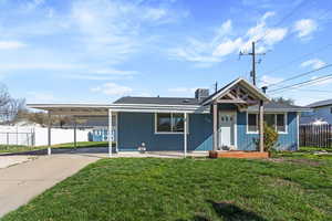 Ranch-style home featuring an attached carport and concrete driveway