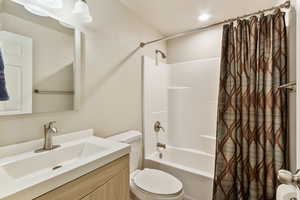 Bathroom featuring vanity and shower / tub combo with curtain