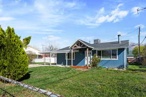 View of front of house featuring covered porch, a carport, and roof with shingles