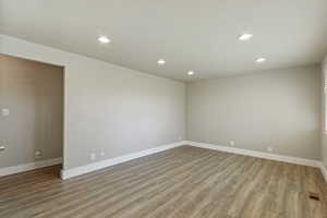 Spare room featuring recessed lighting and light wood-style flooring