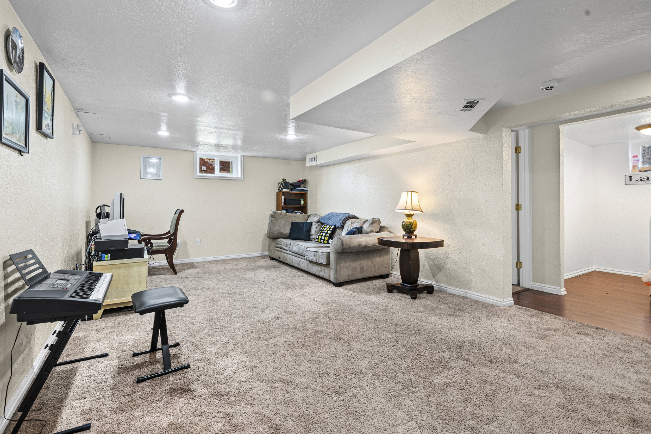 Exercise room with a textured wall, carpet flooring, and a textured ceiling