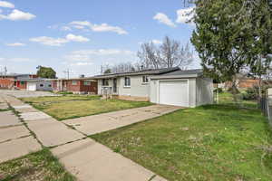 Ranch-style house with brick siding, driveway, an attached garage, and a residential view
