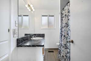 Full bathroom with a shower with curtain and vanity