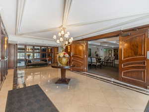 Community lobby featuring crown molding and coffered ceiling