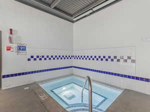 View of swimming pool featuring a hot tub