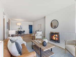 Living area with wood finished floors and a tile fireplace
