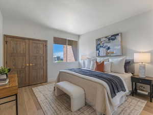 Bedroom with light wood-style flooring and baseboards