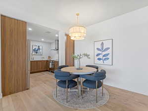 Dining area featuring light wood finished floors and recessed lighting