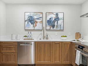 Kitchen featuring stainless steel appliances and wood finish cabinets