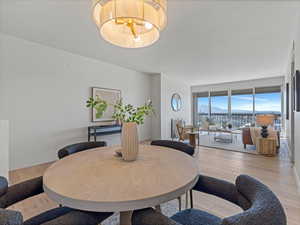 Dining area featuring light wood-style flooring and a mountain view