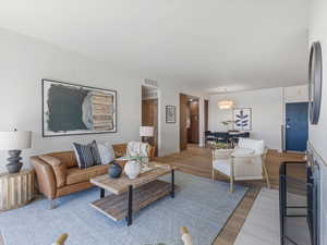Living room featuring light wood-style floors and baseboards
