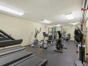 Gym featuring a textured ceiling