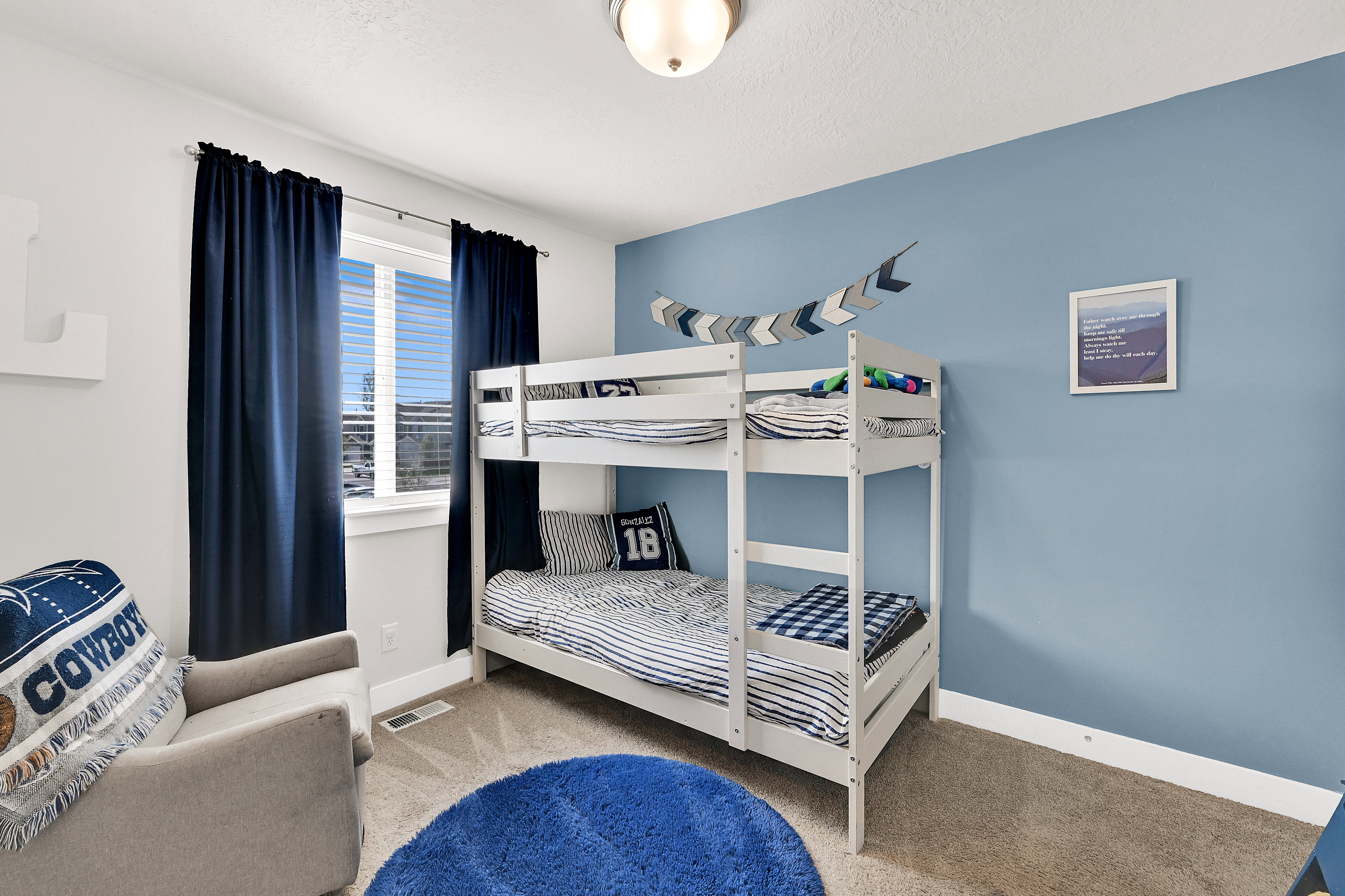 Bedroom featuring baseboards and light carpet