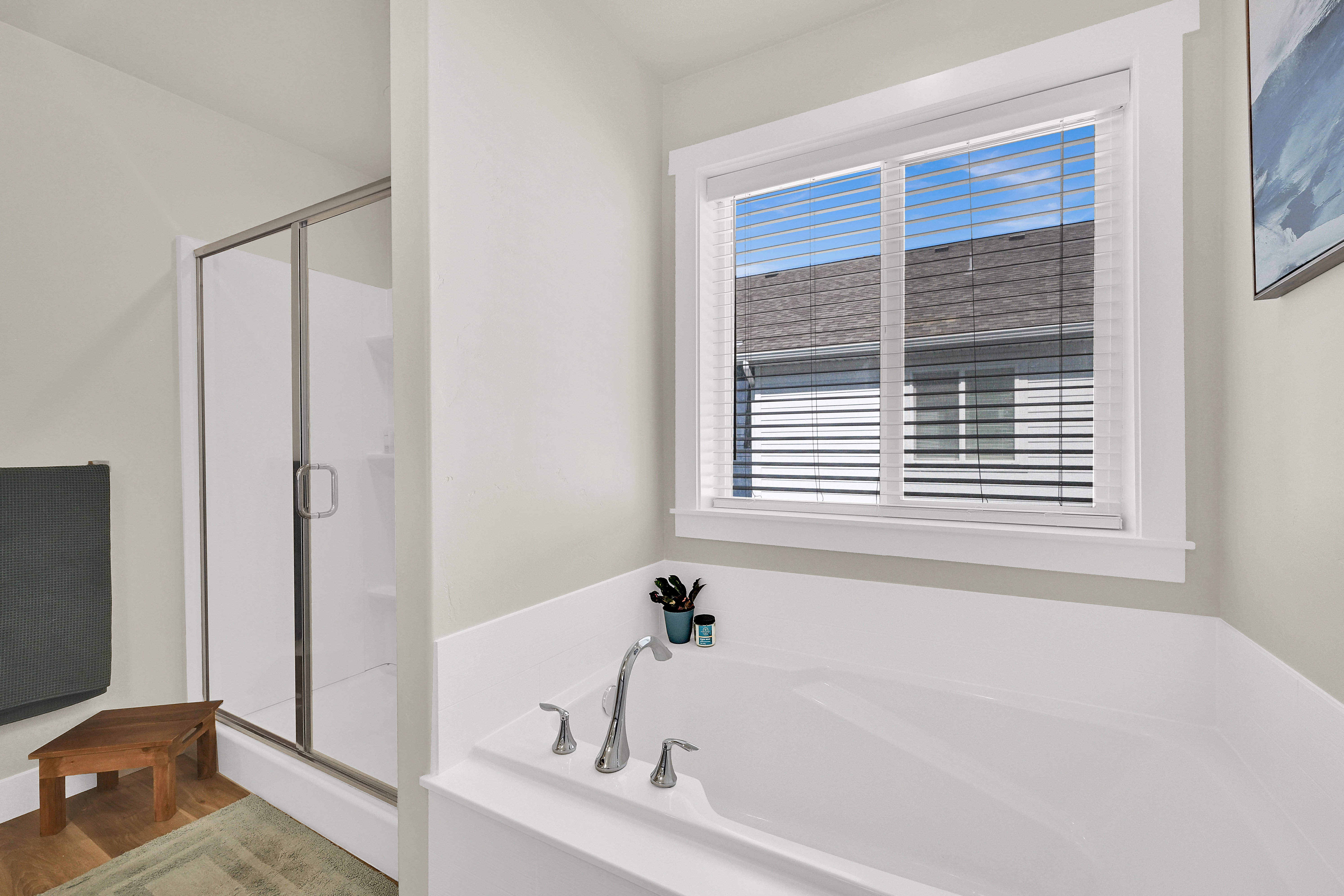 Full bathroom with a shower stall and a garden tub