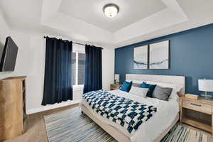 Bedroom with carpet and a tray ceiling