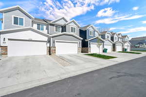 Craftsman house featuring driveway, a residential view, board and batten siding, stone siding, and an attached garage