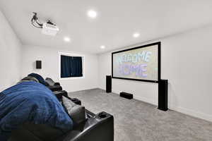 Cinema room featuring light colored carpet and recessed lighting
