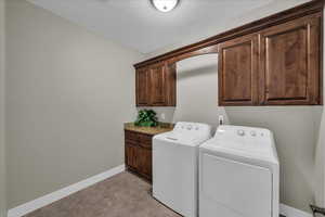 Laundry area with cabinet space and washer and dryer