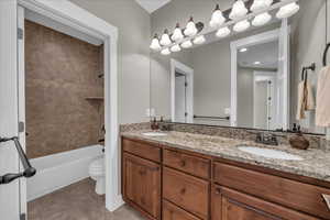 Bathroom with double vanity and shower / bath combination