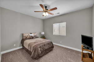 Bedroom featuring a ceiling fan and carpet flooring