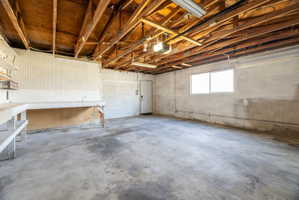 Garage featuring a workshop area and a garage door opener