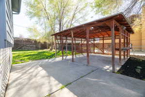 Fenced backyard with a patio
