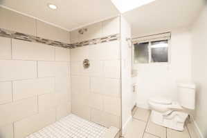 Full bath with light tile patterned floors, a stall shower, and vanity