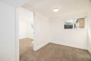 Spare room featuring light colored carpet