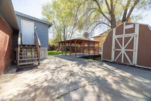 View of patio with a shed and a gazebo