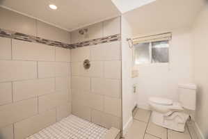 Full bath with a shower stall, light tile patterned flooring, and vanity