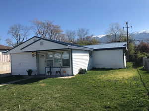 Rear view of house featuring a metal roof