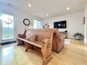 Living room featuring light wood finished floors and recessed lighting