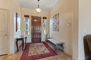 Foyer featuring plenty of natural light and light tile patterned flooring