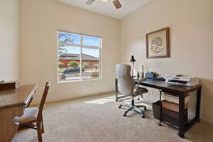Office area featuring light carpet and a ceiling fan