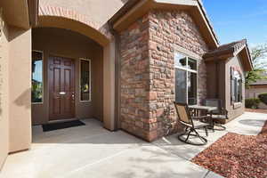 Property entrance featuring stone siding and stucco siding